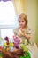 little girl with a large cake with figures of fairy-tale characters