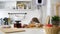 Little girl laughing on the kitchen with brewing teapot