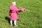 A little girl launches a Foam throwing plane-glider into the field