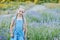 Little girl in lavender field. kids fantasy. Smiling girl sniffing flowers in summer purple lavender field