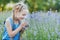 Little girl in lavender field. kids fantasy. Smiling girl sniffing flowers in summer purple lavender field