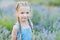 Little girl in lavender field. kids fantasy. Smiling girl sniffing flowers in summer purple lavender field