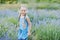 Little girl in lavender field. kids fantasy. Smiling girl sniffing flowers in summer purple lavender field