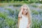 Little girl in lavender field. kids fantasy. Smiling girl sniffing flowers in summer purple lavender field