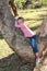 Little girl laying in a gum tree