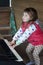 Little girl learning to play piano. Concept of music study and creative hobby