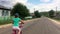 Little girl learning to ride her bicycle. Close up shot of young girl riding on bike outdoors lifestyle.