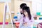 Little girl learning a write with her teacher