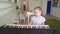 Little girl learns to play the synthesizer.