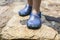 Little girl legs wearing her blue plastic clogs