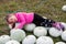 Little girl lies on pumpkins