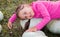 Little girl lies on pumpkins