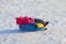Little girl lies on snowtube down from hill
