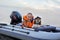 Little girl in a life jacket with her dog in a boat on the lake. Safety. summer rest