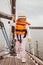 Little Girl in Life Vest Staying on the Sailboat, Yachting, Cloudy Sky