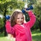 Little girl lifting dumbbells