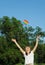 A little girl lifts a toy pop it to the sky