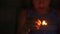 A little girl lights matches in the dark. Danger to the child, protection of children, correct education