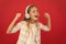 Little girl listen song headphones. Online radio station channel. Girl child listen music modern headphones. Get music