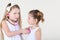 Little girl listens heartbeat of another girl by toy phonendoscope