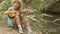 Little girl with long blond hair in straw hat