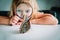 Little girl looking at butterfy through magnifying glass