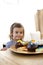 Little girl looking at confectionery at home