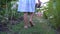 little girl looking for Easter eggs with basket in hand, entertainment for children in Catholic Easter, close-up of legs