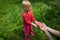 Little girl looking at and exploring lizard in nature