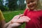 Little girl looking at and exploring lizard in nature