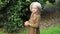 Little girl looking at an orange tree