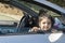 Little girl looking out the window of a car in outdoor area