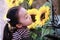 Little girl looking Summer Flowers