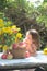 Little girl looks at a bouquet of flowers