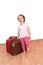 Little girl with luggage ready to leave isolated