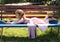 Little girl lying on bench