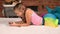 Little girl lying on carpet texting on the phone