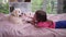 Little girl lying on cozy bed with puppy