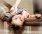 Little girl lying down talking on a wired phone