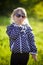 Little girl lying on the grass sunglasses