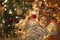 Little girl lying under Christmas tree and holding a present