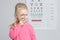 Little girl with magnifier visiting children`s doctor