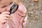Little girl with a magnifying glass in her hand investigate  details of spring nature . Springtime outdoor kids activity and