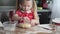 A little girl makes a cake.