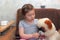 Little girl makes inhalation for herself and a Chinese soft toy with a medical inhaler