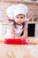 Little girl making dough for bakery