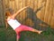 Little girl making figures from shadow on wooden fence background