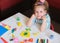 Little girl making flower with center earth planet shape from plasticine, Home Education game with clay. Early development and