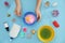 Little girl making slime toy on light blue background