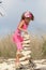 Little girl making a Stone cairn